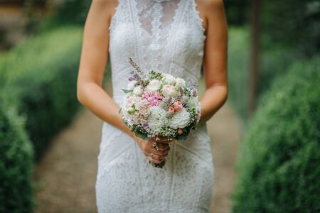 Bride holding flower bouquet close upの写真素材