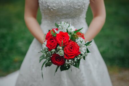 Bride holding flower bouquet close upの写真素材
