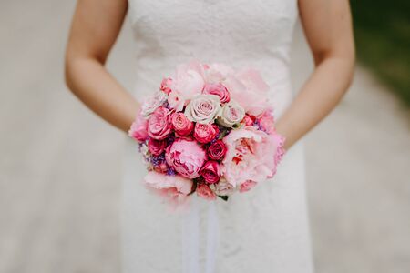 Bride holding flower bouquet close upの写真素材
