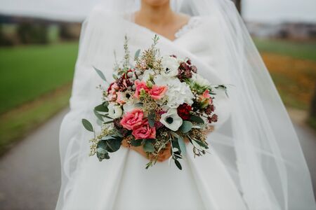 Bride holding flower bouquet close upの写真素材