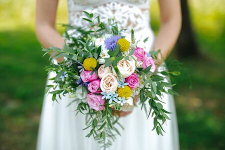 Bride holding flower bouquet close upの写真素材