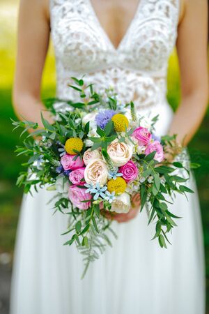 Bride holding flower bouquet close upの写真素材