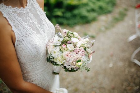 Bride holding flower bouquet close upの写真素材