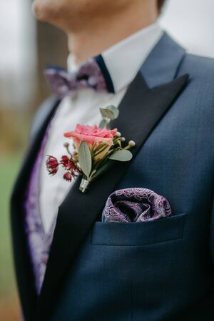 Boutonniere, groom wearing flowers on his jacketの写真素材