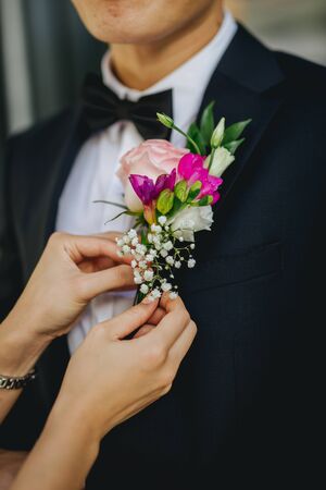Boutonniere, groom wearing flowers on his jacketの写真素材
