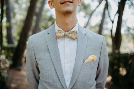 Groom wearing a bow tie at a weddingの写真素材