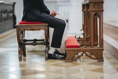 Bride and groom sitting side by side at the wedding ceremonyの写真素材