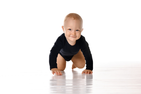 pretty crawling baby girl isolated on white backgroundの写真素材