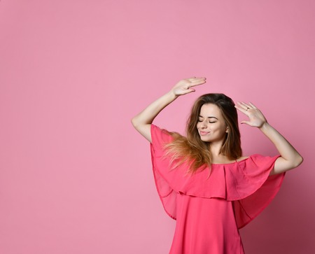 Student female having fun while dancing to some pleasant music indoors.の写真素材