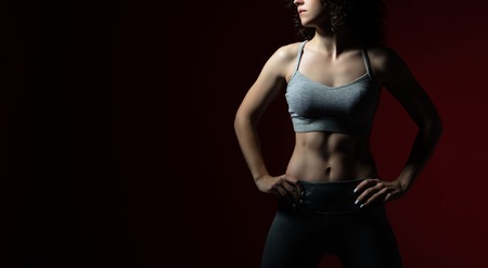 Low key of Female in sportswear showing her great bodyの写真素材