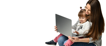 happy mother with adorable little girl with laptop . childhood, parenting and technology concept ....