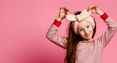 portrait of winsome girl in her pink pajamas and a soft headband is painted in the frame. Pleasant dreamsの写真素材