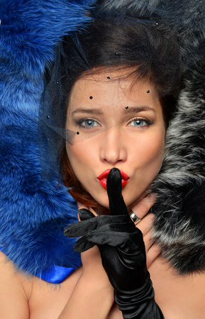 Luxurious young brunette lies in a multi-colored furs. Concept of wealth and affluence, luxury and moneyの写真素材