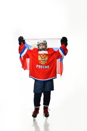 Moscow, Russia, January 2017 - boy hockey player in the form of a Russian team holds a flag over his headの写真素材