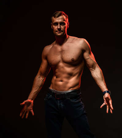 Handsome sexy man with muscular body showing welcome gestureの写真素材