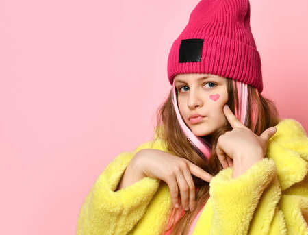 Close up portrait of modern bright confident teen girl on pink background.
