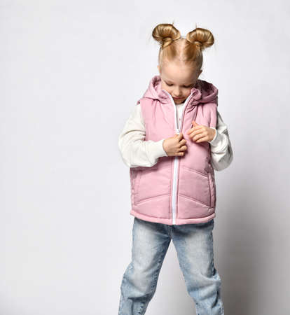 fashionable girl posing in autumn waistcoat, isolated on lightの写真素材