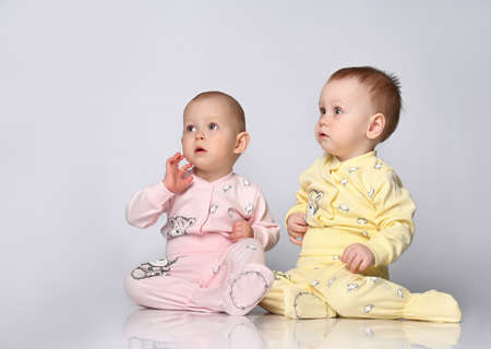 two babies talking on white background.の写真素材