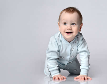 side view of pretty crawling babyの写真素材