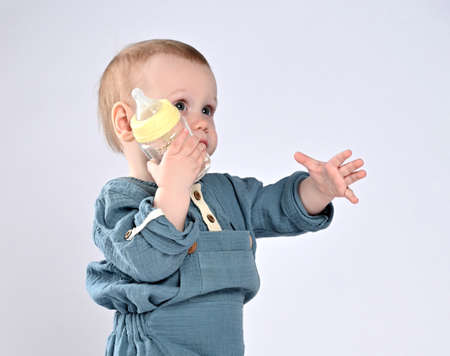 adorable child drinking from bottle.