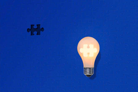 Idea symbol, light bulb and jigsaw puzzle missing piece の写真素材