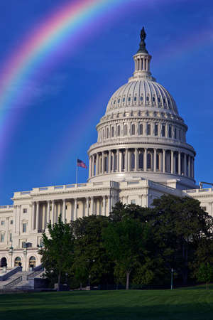 West side view of the United States Capitol building under the rainbowの写真素材