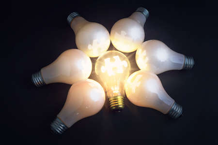 Idea symbol, light bulbs and jigsaw puzzles 