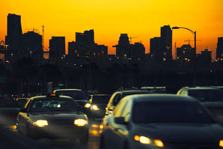 Traffic at nightfall in city with Miami Skyline on background の写真素材