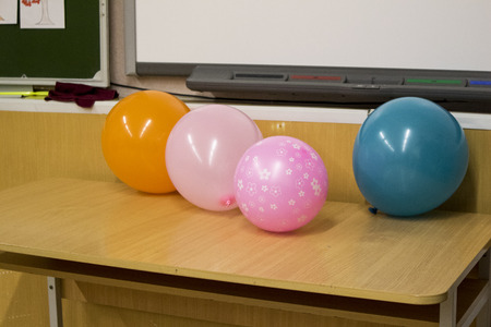 Holiday balloons near the school board and interactive booth in the classroom.の写真素材