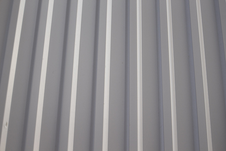 Solid background by metal riffle wall full of grey steel color.