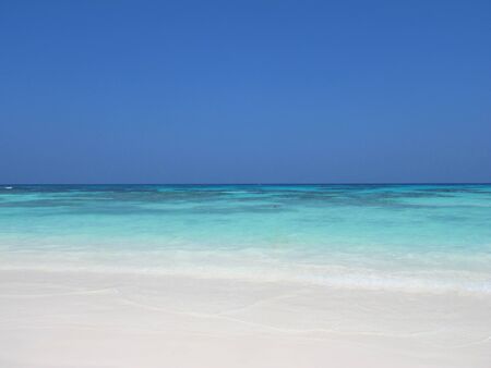                                Clear blue sky and sea with white sand at the beachの写真素材