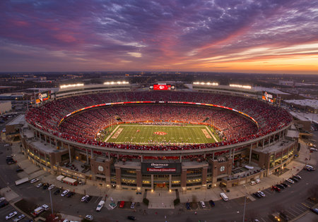 Aerial view of a massive stadium glowing under sunset hues.の写真素材