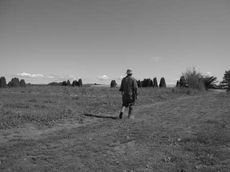 sole farmer crosses his fieldの写真素材
