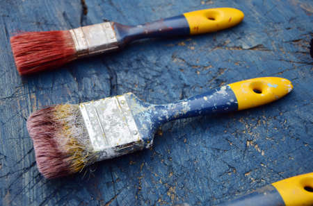 old paint brushes on wooden backgroundの写真素材