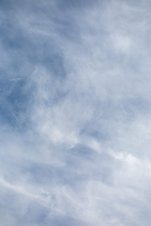 Blue sky with white clouds, vertical nature backgroundの写真素材