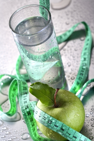 Healthy concept - apple glass of water and tapeの写真素材