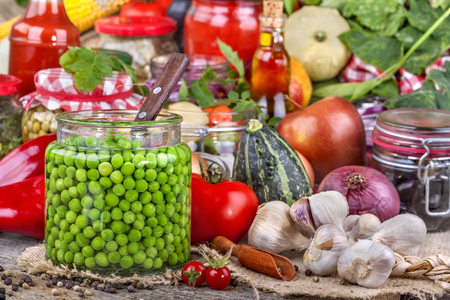 Canned peas with different fruits and vegetables in the backgroundの写真素材