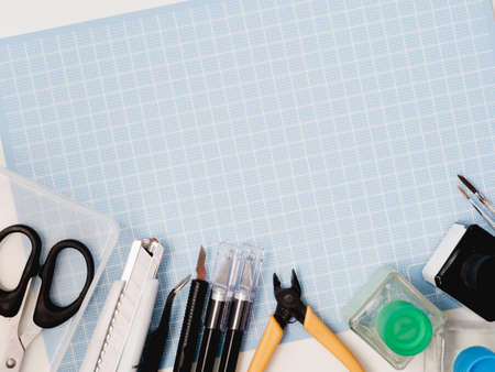 top view of hobbies concept with cutting mat and tool kits on white background with copy space.の写真素材