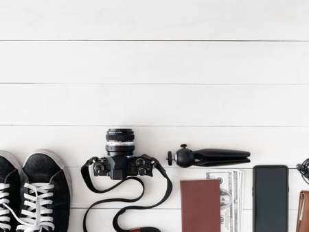 top view travel concept with digital  camera, map and Outfit of traveler on white table background,...