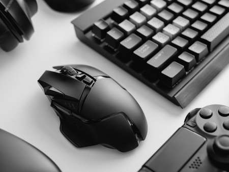 gamer work space concept with gaming gear, mouse, keyboard, joystick, headset on white table...