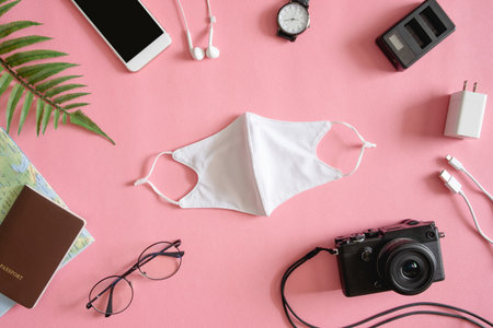 top view travel concept with camera, map, passport and fabric mask, Tourist essentials, vintage tone effectの写真素材