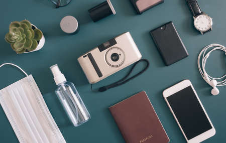 top view travel concept with camera, map, passport and disposable face mask, Tourist essentials, vintage tone effectの写真素材