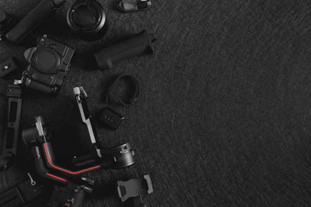top view of work space photographer with digital camera, Gimbal Stabilizers and camera accessoryの写真素材