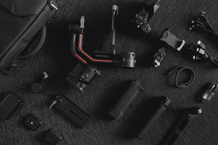 top view of work space photographer with digital camera, Gimbal Stabilizers and camera accessoryの写真素材