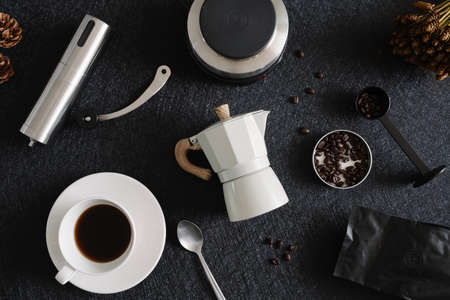 coffee cup and moka pot on black table background in kitchen room, coffee shop.の写真素材