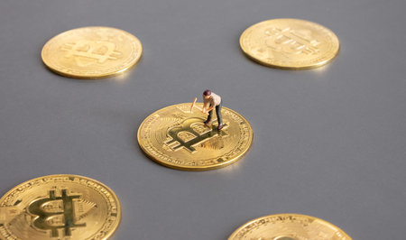 cryptocurrency concept with bitcoin symbol and Miniature human on Golden coins