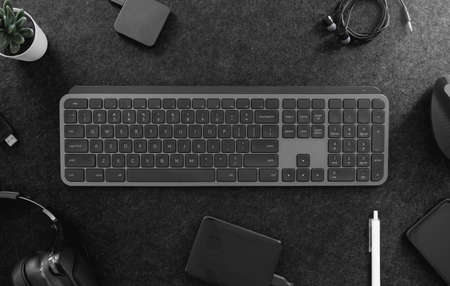 top view of office desk table with keyboard, mouse, smartphone and accessory on table.の写真素材
