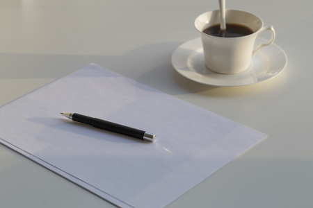 Business concept , blank paper and cup of fresh coffee on the table in officeの写真素材