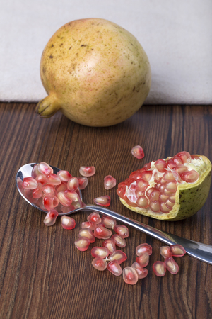 Pomegranate and seeds on the tableの写真素材