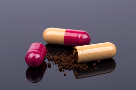 Orange open pill on the black backgroundの写真素材
